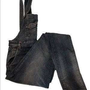 Distressed overall skinny jeans